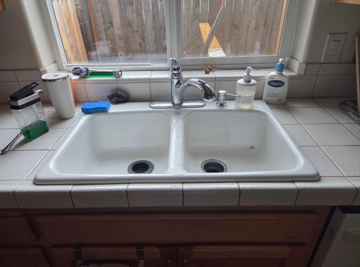 Kitchen sink before replacement by Table Rock Plumbing Solutions